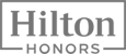 The image is a logo for "Hilton Honors," with the text enclosed in a rectangular border.